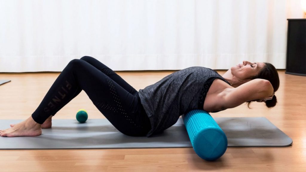 woman exercising on a foam roller