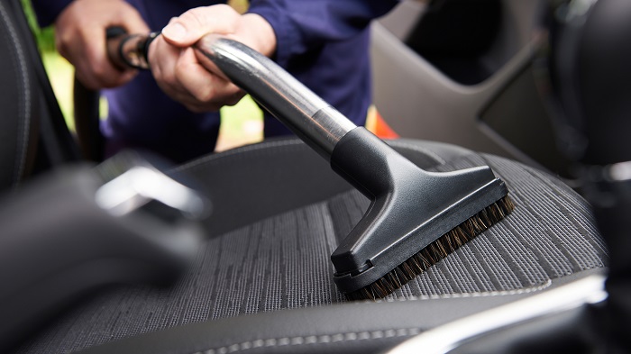 Man Hoovering Seat Of Car During Car Cleaning; Shutterstock ID 290850902; PO: today.com mish