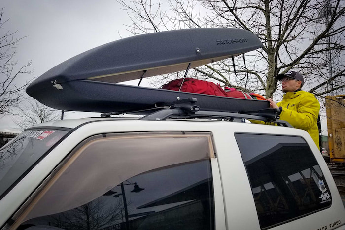 man adjusting his car roof rack