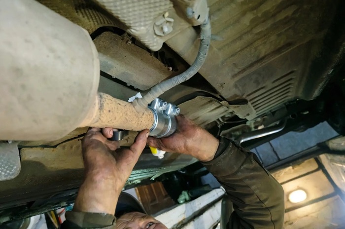 a person working on a aftermarket exhaust for a toyota landcruiser series 79
