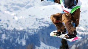 guy doing trick on snowboard