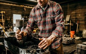 guy wearing flannel shirt working