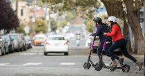 Couple ridding Adult Scooter