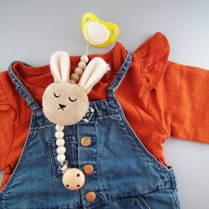 picture of red blouse, denim onesies and baby dummy holder