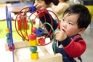 picture of a kid playing with an educational toy
