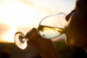 A Women Drinking White Wine