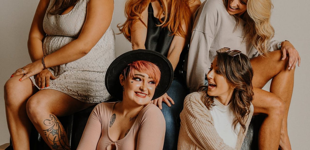 picture of women in different type of bodies sitting in front brown background