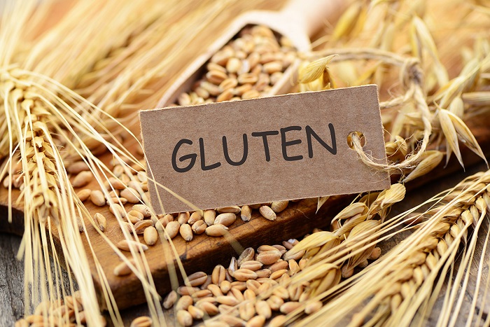 wheat grains with gluten card on table 