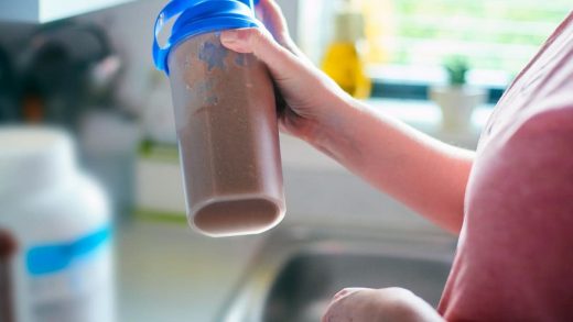 a person shaking a protein shake which is best used for weight loss