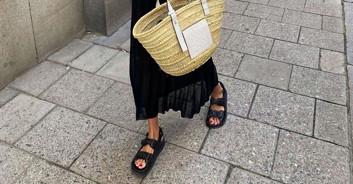 picture of a woman walking wearing a dress and a dress sandals 