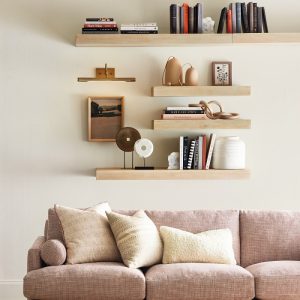 bookshelves full of books above the bed
