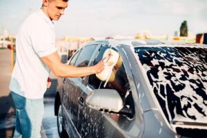 man washing his car