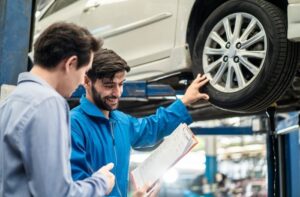 guy talking to the mechanic at his workshop