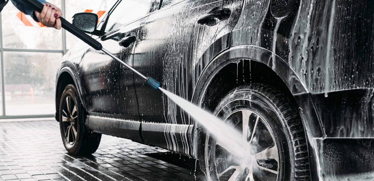 man washing his car at a car wash