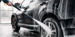 man washing his car at a car wash