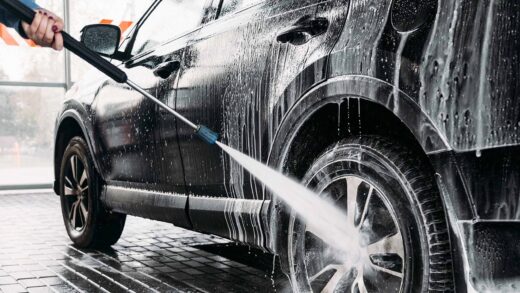 man washing his car at a car wash