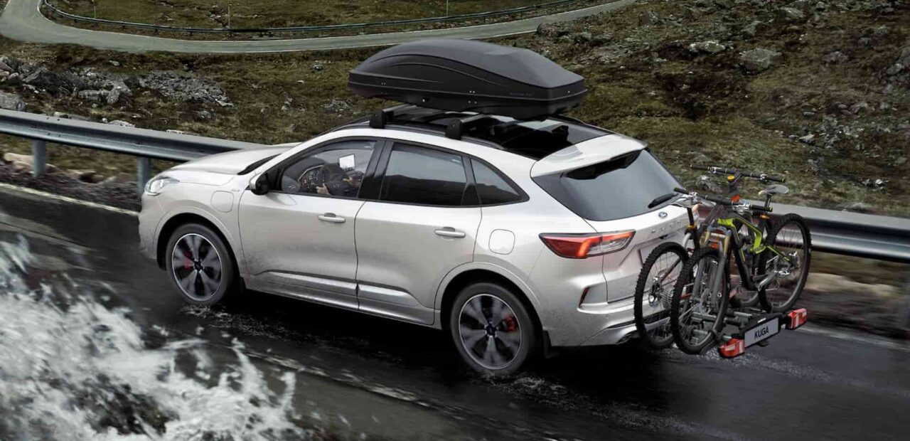 a ford with a roof rack on the road