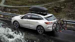 a ford with a roof rack on the road