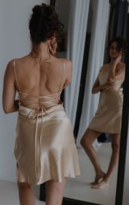 woman wearing mini beige slip dress