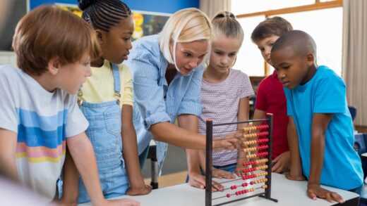 teacher with children using teaching aid and props