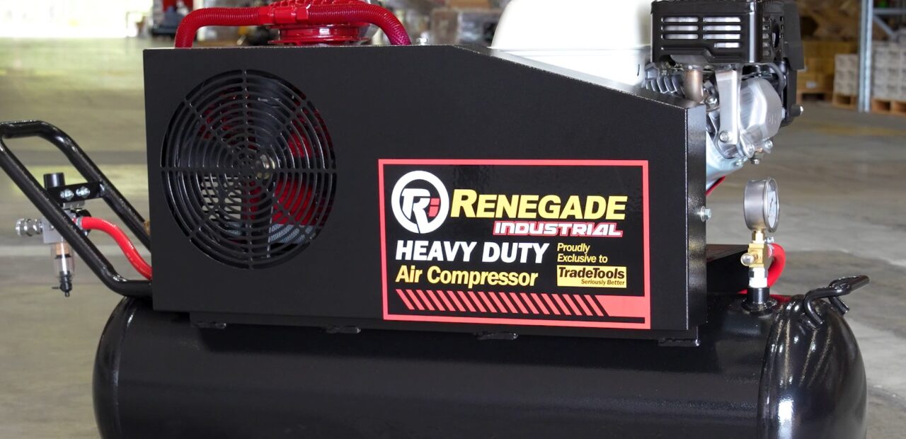 Renegade Industrial heavy-duty air compressor with a black horizontal tank and red detailing, positioned in a warehouse.
