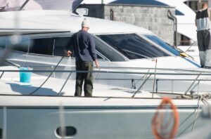 man washing his boat