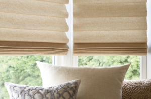 blinds of fabrics on a window and pillows below them
