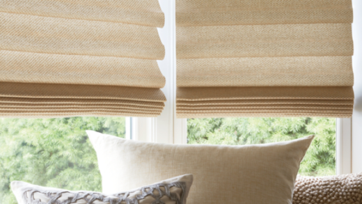 blinds of fabrics on a window and pillows below them
