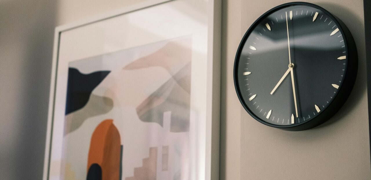 wall with art print and clock