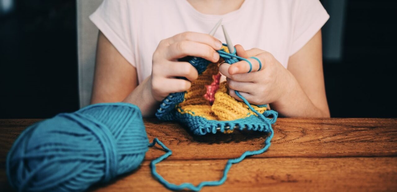 woman knitting with needles