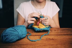 woman knitting with needles
