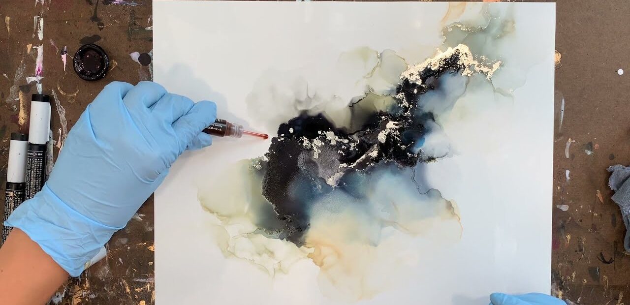 woman creating abstract art with alcohol ink