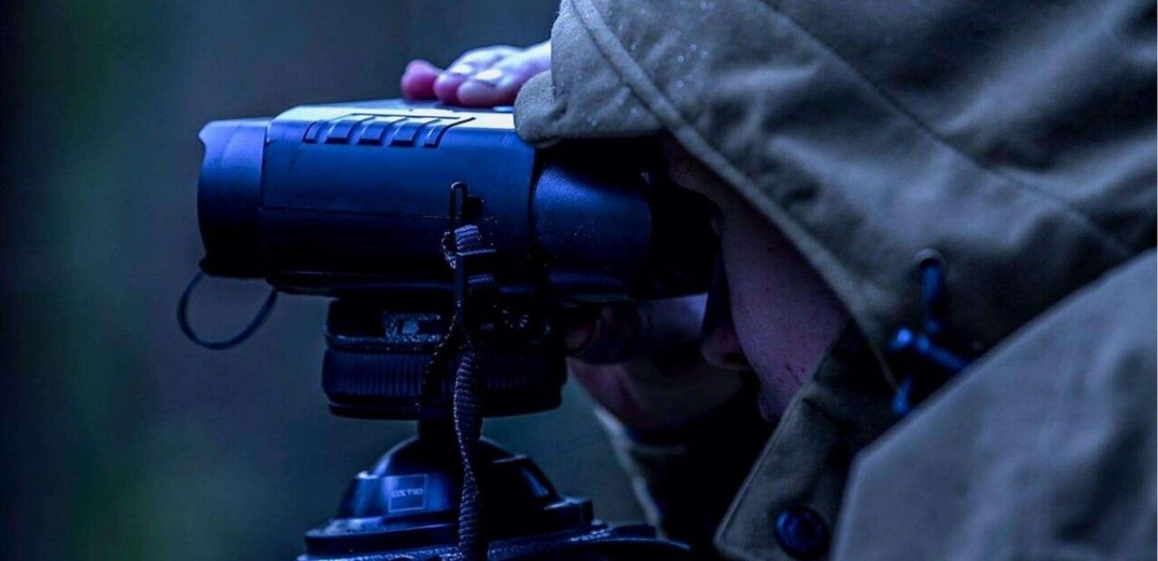person using night vision binoculars