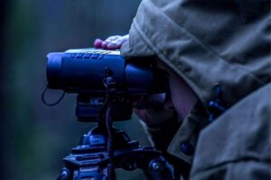 person using night vision binoculars