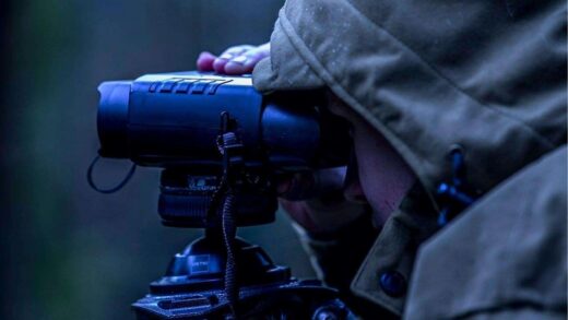 person using night vision binoculars
